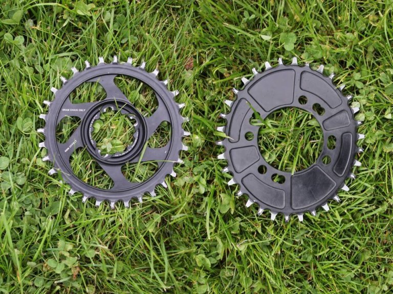 An oval chainring next to a normal one.