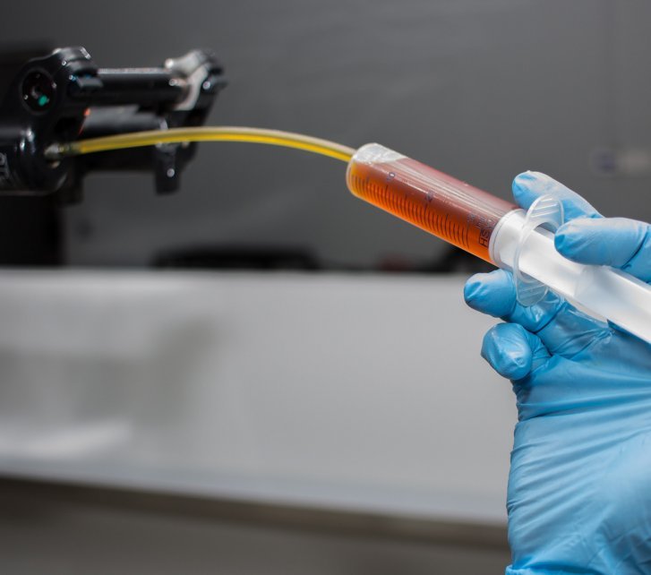 A bc mechanic fills a suspension fork with new fork oil.