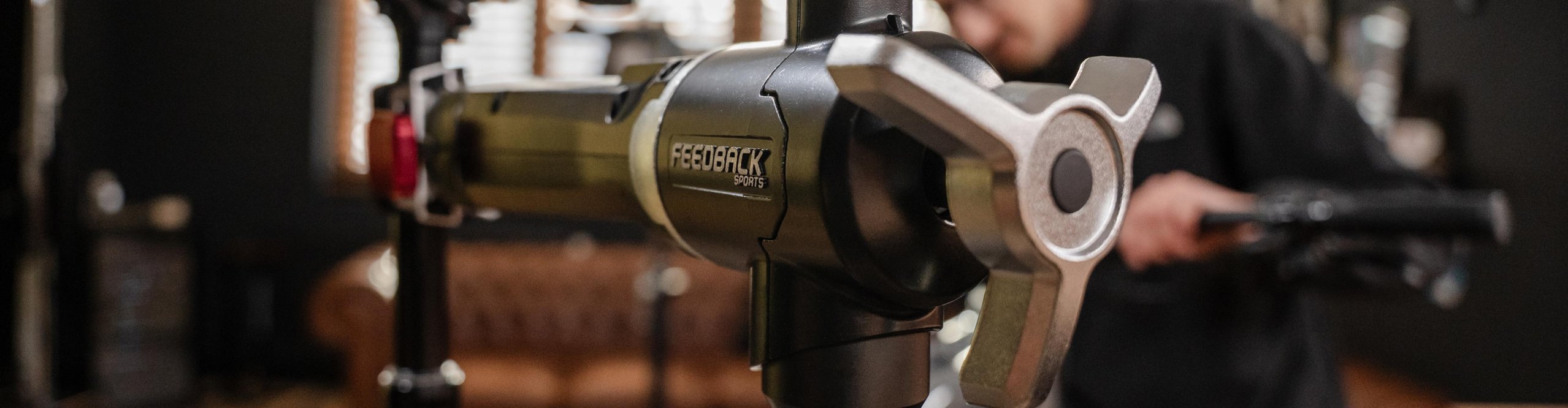 Feedback Sports repair stand with clamp head in a bicycle workshop.