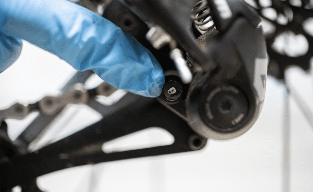 Our mechanic activates the lockout function of a SRAM rear derailleur.