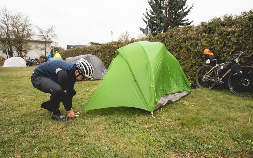 Marcel stakes out his tent. 