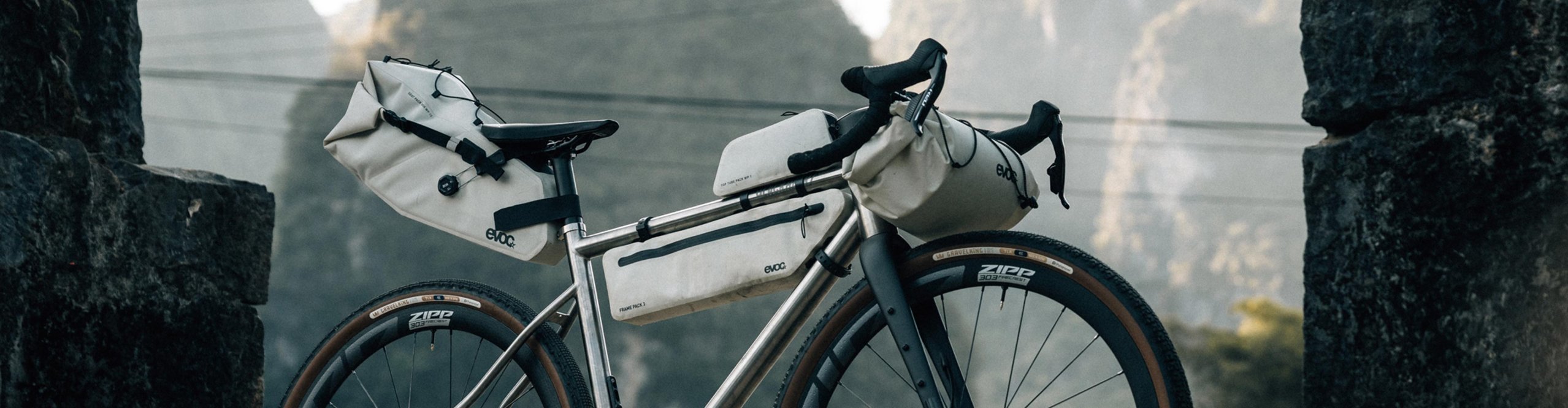 EVOC bikepacking bags on a gravel bike with frame bag, handlebar roll and saddle bag in the mountains of China