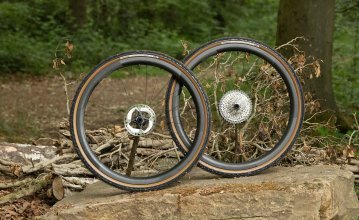 Ein Novatec Laufradsatz mit Panaracer Gravelking Reifen drapiert auf einem Stein. 