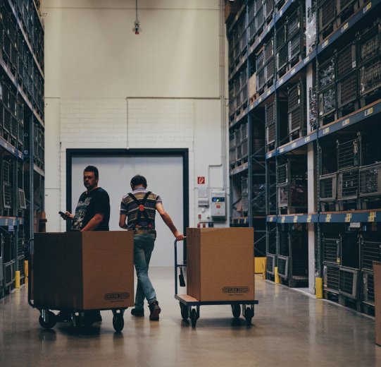 A look inside the Ortlieb warehouse. On the left and right are heavy-duty shelves that rise up to the ceiling.