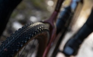 Pictured is the rear wheel of a 3T gravel bike. The focus of the image is on the tread of the tyre. 