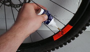 Inserting the sealant through the valve hole.