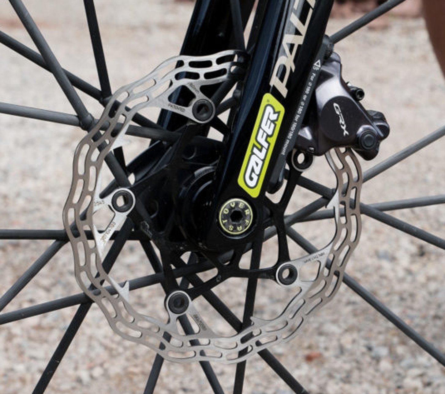 Close-up of the Galfer brake rotor and Shimano GRX brake caliper on the front wheel of a Basso Palta gravel bike.