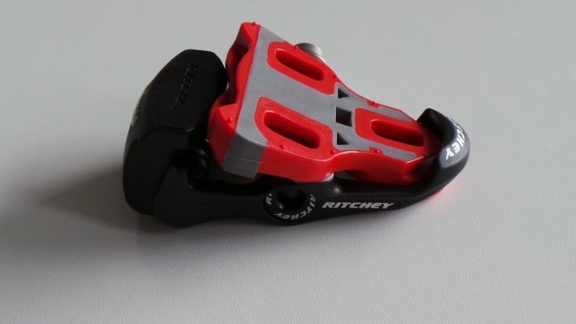 Ein Rennrad Klickpedal und das dazugehörige Cleat