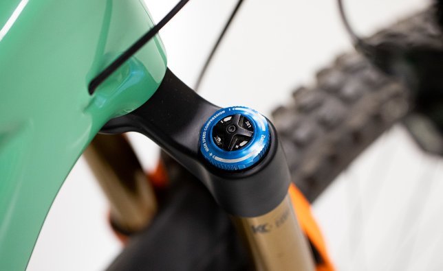 Pictured here is a Fox suspension fork. The focus of the image is on the top cap for setting the high-speed and low-speed compression.