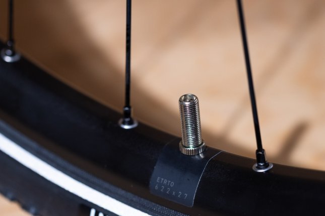 Detail photo: A Schrader valve installed in a bicycle rim