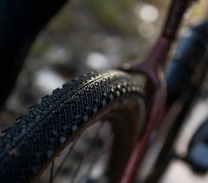 Pictured is the rear wheel of a 3T gravel bike. The focus of the image is on the tread of the tyre. 