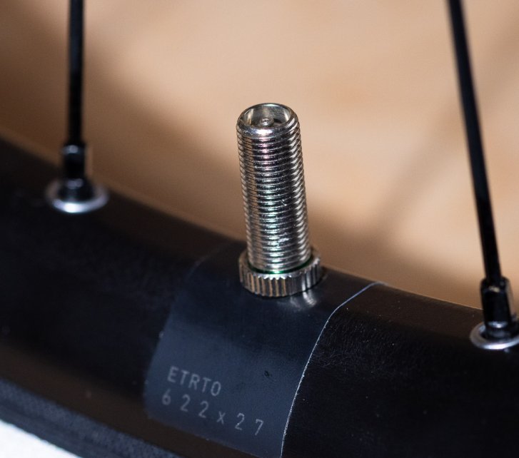 Detail photo: A Schrader valve installed in a bicycle rim