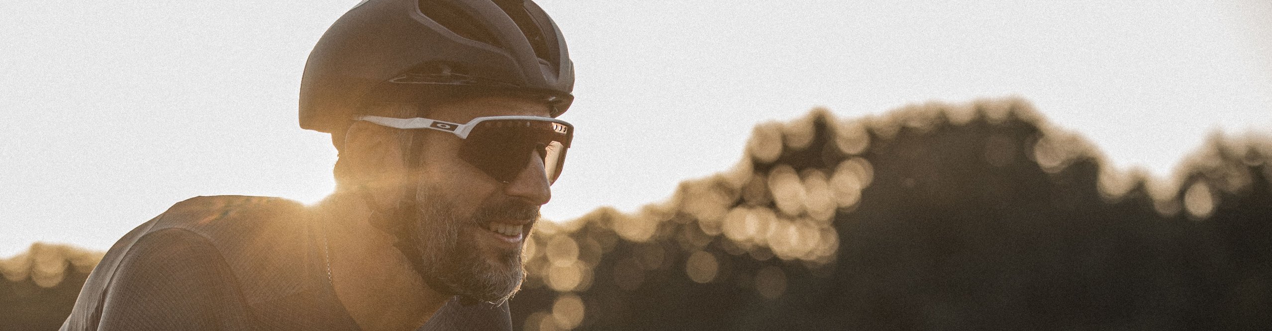 Rennradfahrer als Portraitbild mit Oakley Fahrradbrille in abendlicher Stimmung unterwegs.