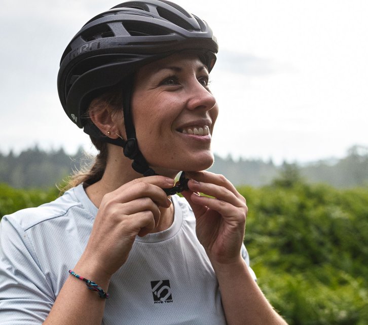 Susanne from bc fastens the buckle on her gravel helmet. 