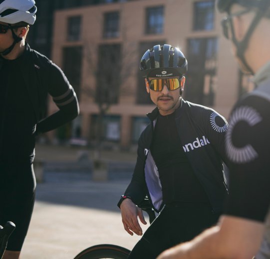 Franjo from the bc Team sits on the top tube of his bike before the ride.