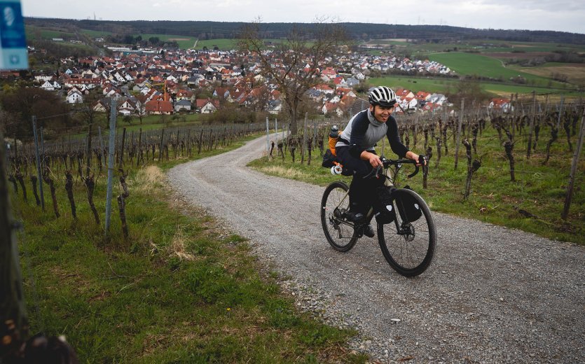 Marcel fährt erschöpft, aber gut gelaunt einen sehr steilen Weinberg hinauf. 