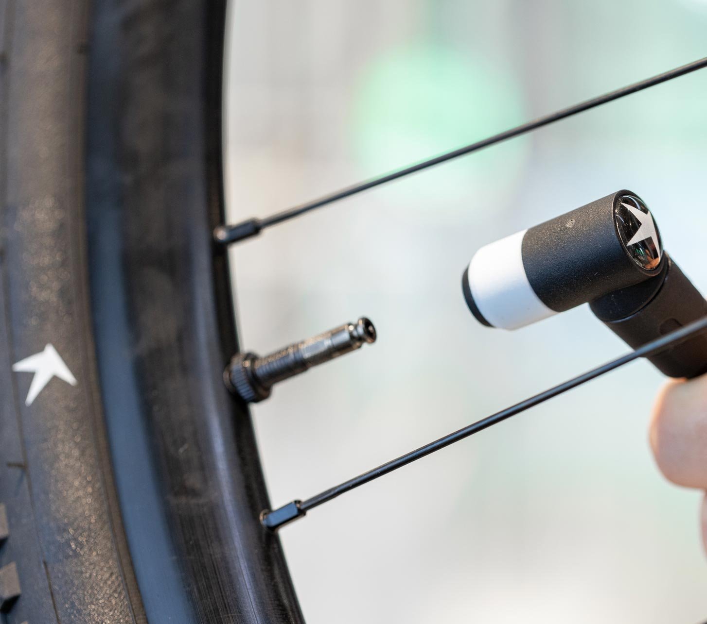 Schwalbe Clik Valve on a bicycle tire during fast inflation with a bike pump – close-up of the modern bicycle valve on wheel and rim