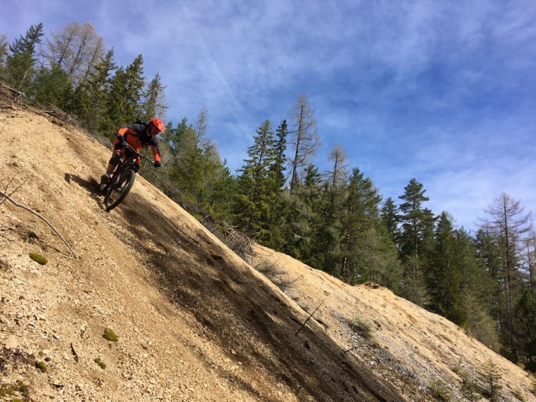 Surfing down a loose gravel grade.