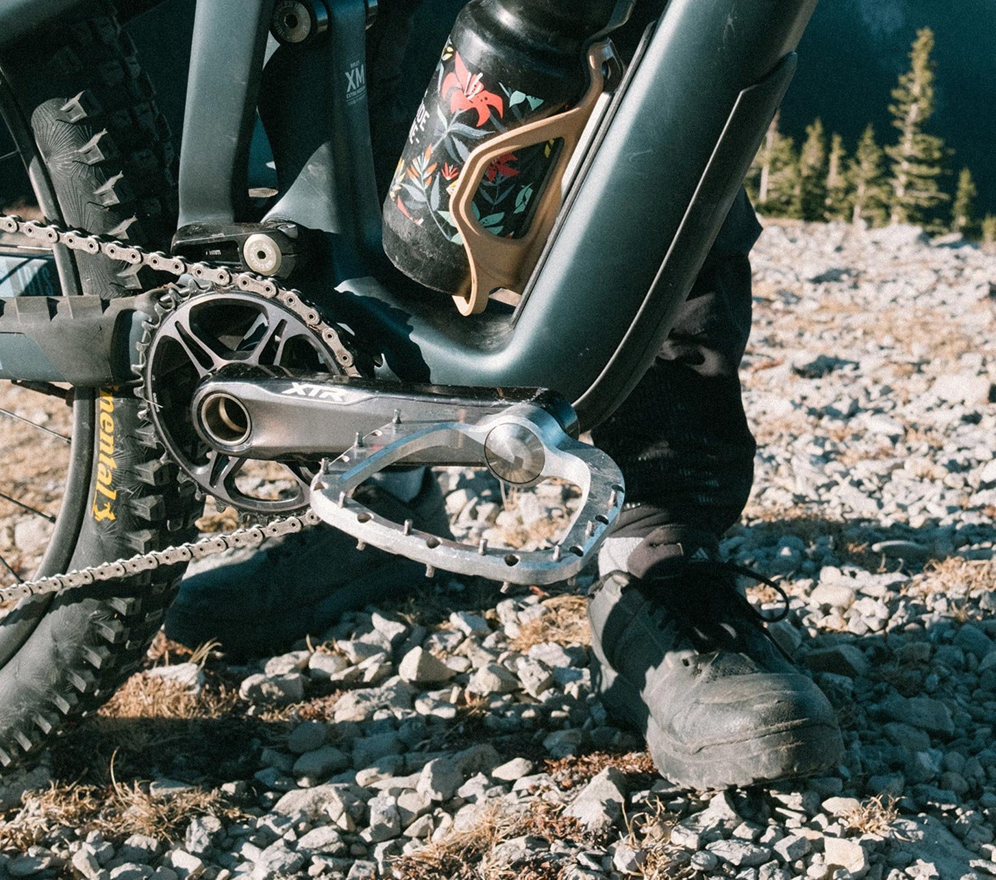Outlier Void pedals on a mountain bike on a rocky trail with Continental Kryptotal tires in the mountains.