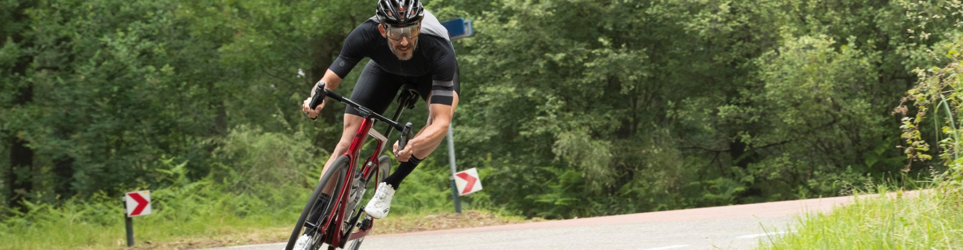 Un coureur cycliste de course en maillot et cuissard de bc original dévale une descente sur un Factor One. 