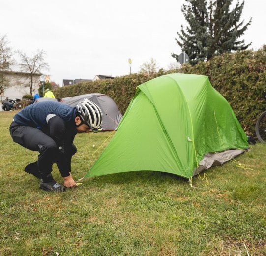 Marcel stakes out his tent.