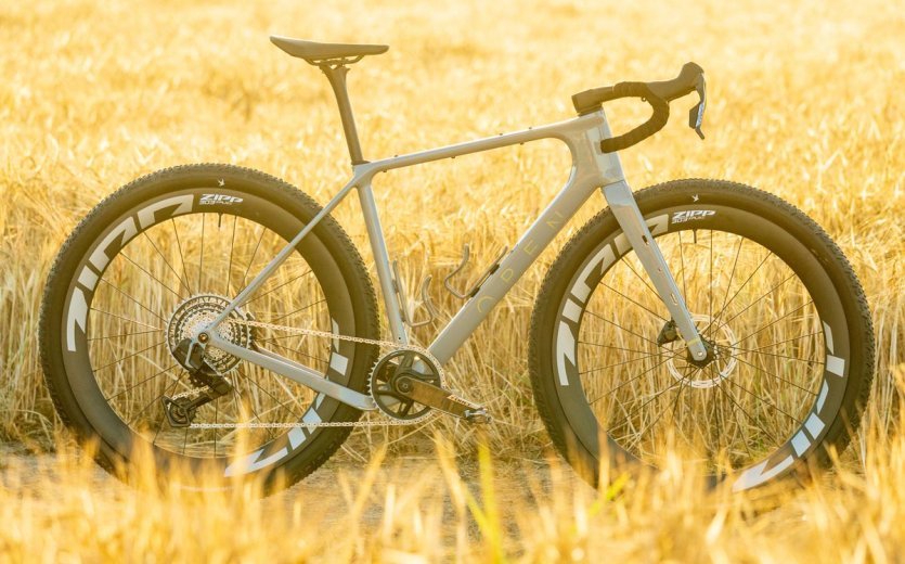 OPEN WI.DE gravel bike with Zipp wheels, wide tires and 1x drivetrain in a golden field.
