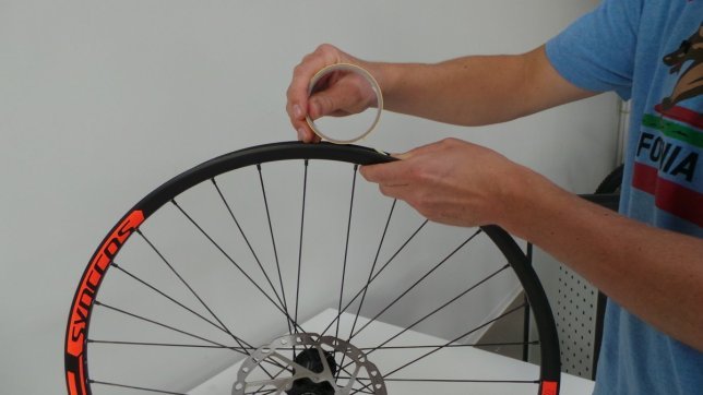 Applying the rim tape, using a little bit of tension.