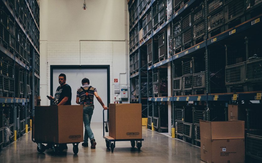 A look inside the Ortlieb warehouse. On the left and right are heavy-duty shelves that rise up to the ceiling.