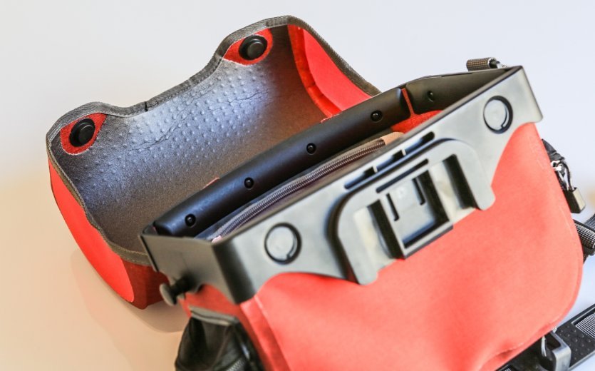 Close-up of an open red ORTLIEB handlebar bag showing the mounting system.