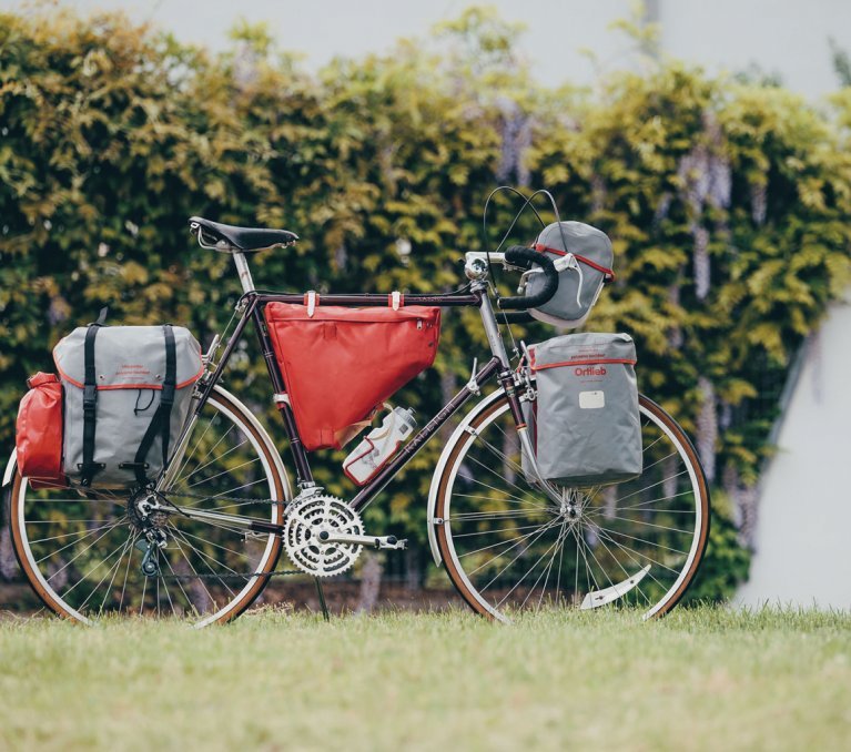 En la imagen, una bicicleta de ruta de acero equipada con varias bolsas de Bikepacking de la firma Ortlieb.