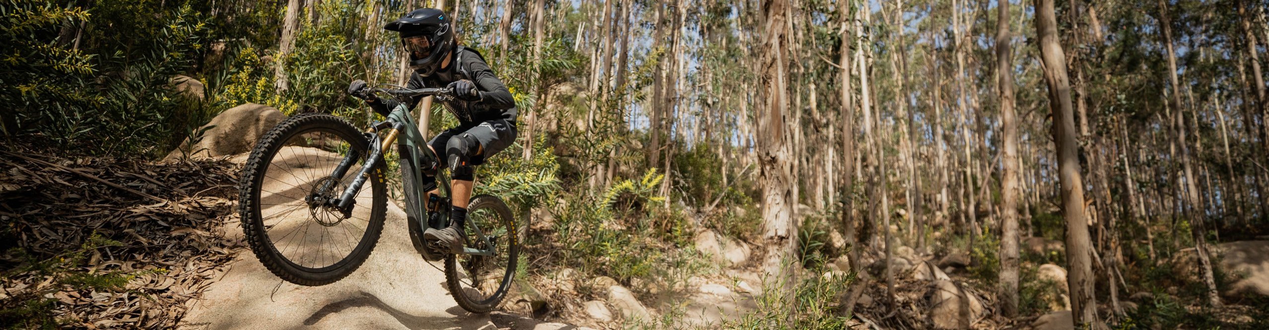 E-Mountainbike Fahrer springt über Hügel