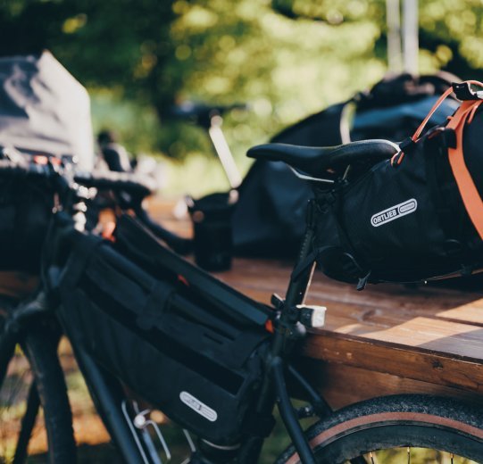 En la imagen es una bicicleta Gravel equipada con bolsa de cuadro y bolsa de sillín de Ortlieb.