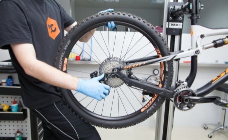 The rear derailleur is pulled back to make it easier to release the wheel. 