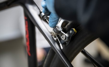 The bc mechanic loosens the quick release on the brake body to open the rim brake. 