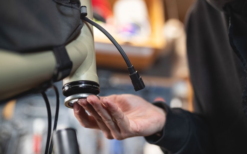 bc Mechanic Pascal inserts the lower bearing of a headset.