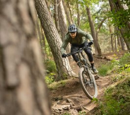 Berno heizt mit einem E-MTB durch den Wald. 