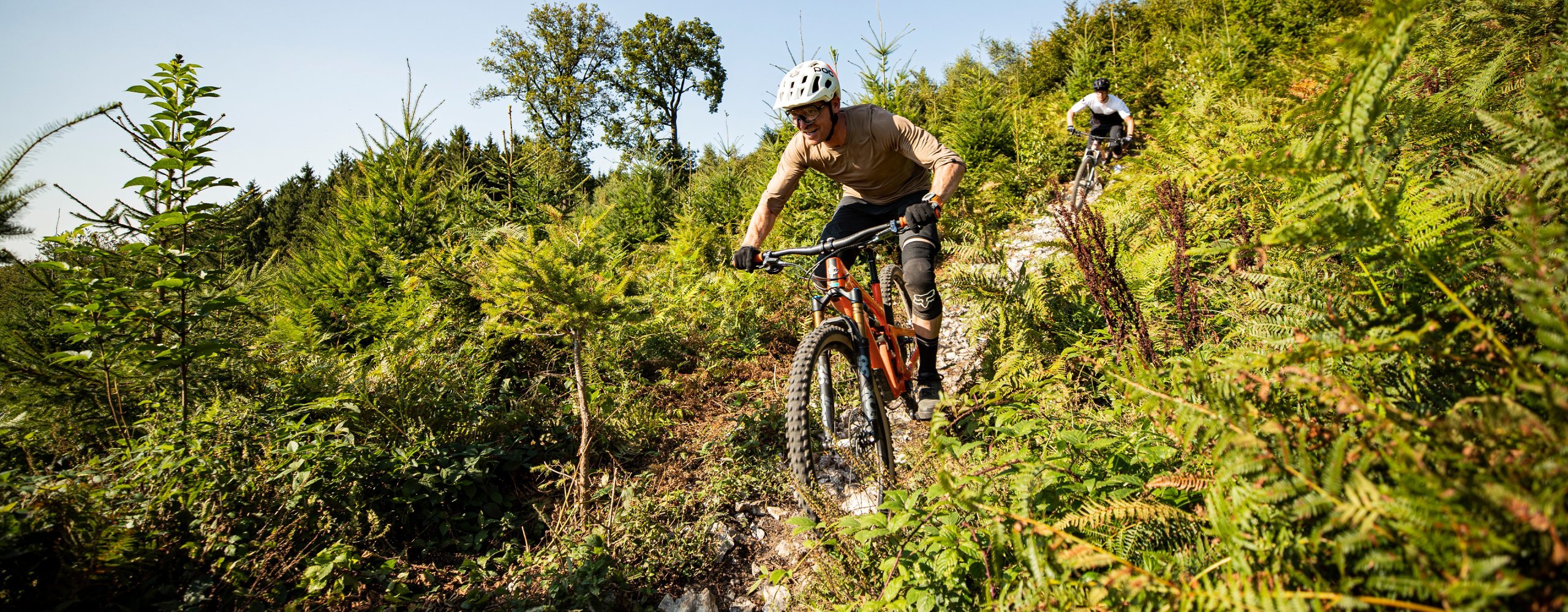 Mountainbiker rasen grüne Landschaft herunter