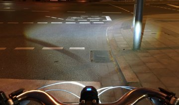 The powerful beam is even visible under a bright street light.