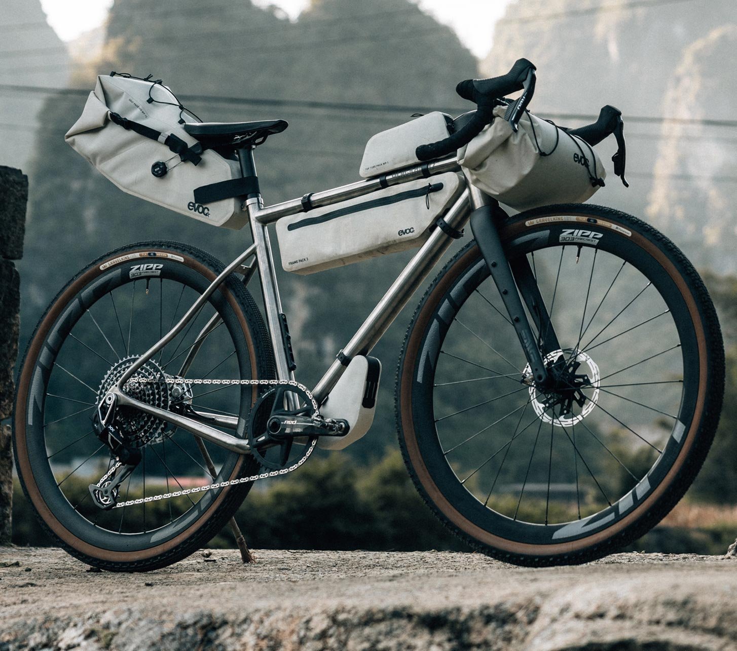 EVOC bikepacking bags on a gravel bike with frame bag, handlebar roll and saddle bag in the mountains of China