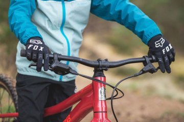 Child riding a kids bike with ergonomic handlebar grips and easy-to-reach brake levers designed for small hands.