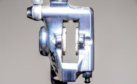 Vue frontale d’un étrier de frein Shimano XTR avec les pistons rétractés clairement visibles.