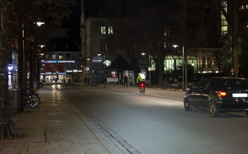 Biker in city traffic during evening hours.