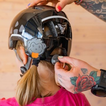Kids bike helmet being adjusted at the rear fit system to ensure a secure and comfortable fit.