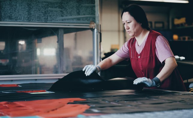An Ortlieb employee checks cut-out pieces of fabric for a bag.
