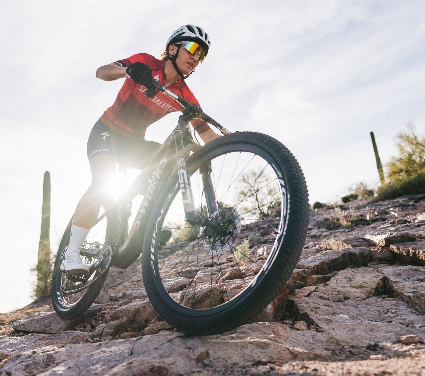 Mountainbikerin fährt durch einen Wüsten-Trail