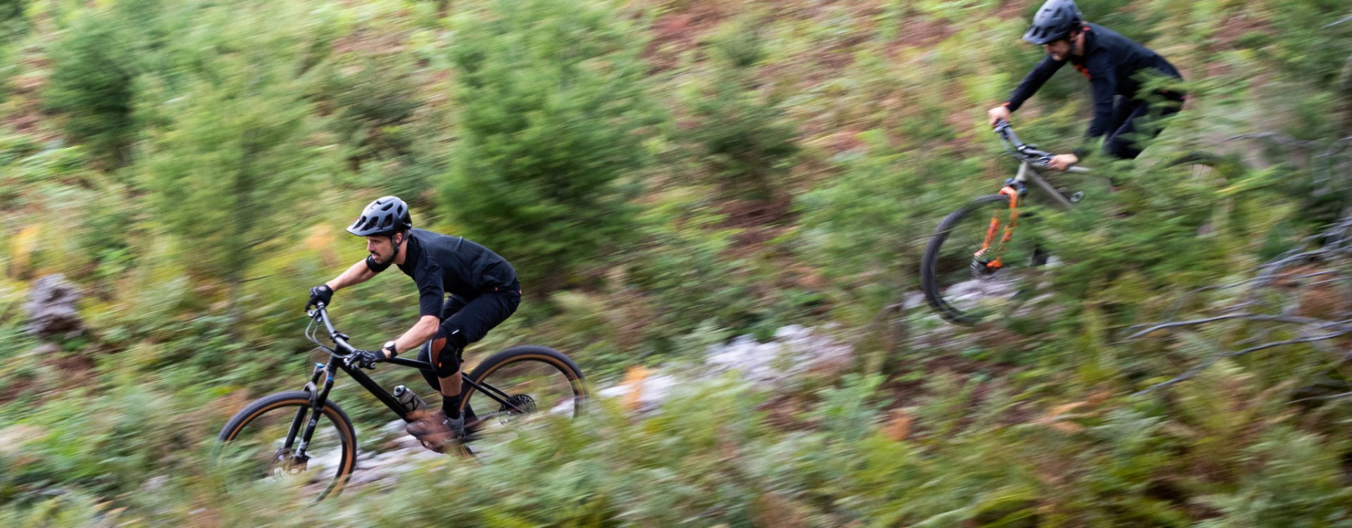 Georg et Chris de l’équipe de bc dévalent une pente sur leurs vélos bc original Podsol.