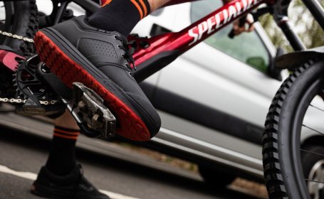 Pictured is a mountain biker. The focus of the picture is on the shoe clicked into the pedal.