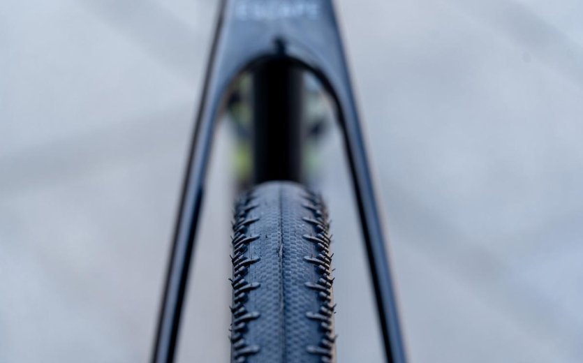 Detail view of tire clearance and fork on the OPEN U.P.PER gravel bike with treaded front tire.