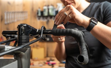 Die Mechanikerin klebt das Abschlussband auf.