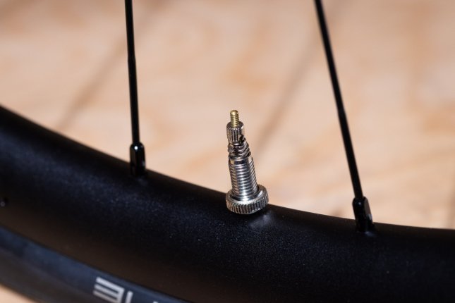 Detail photo: A Presta valve installed in a bicycle rim